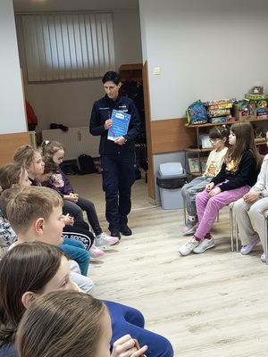 zdjęcie kolorowe na zdjęciu policjantka podczas spotkania z dziećmi na półkoloniach